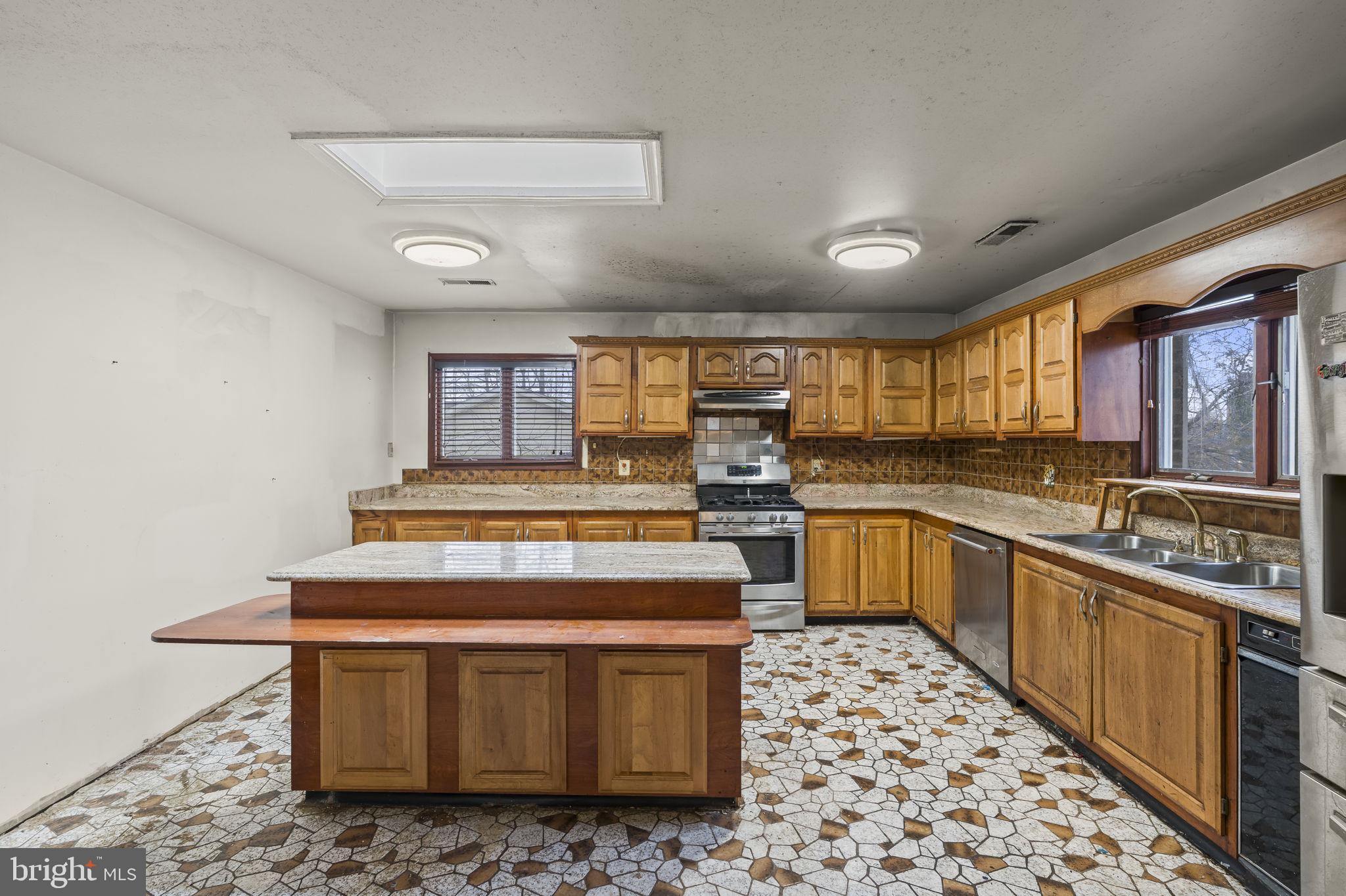 7811 Heflin Drive Clinton, MD 20735 - Photo 16 of 55 a kitchen with stainless steel appliances granite countertop a stove a sink and a refrigerator