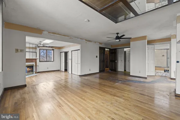 a view of an empty room with a fireplace and a window