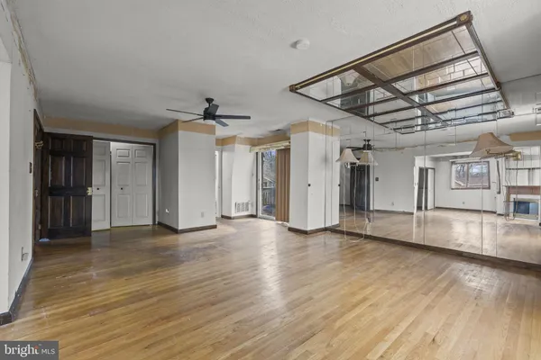 a view of an empty room with wooden floor