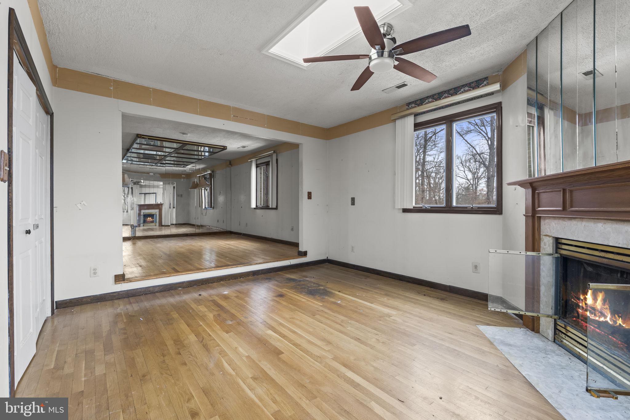 7811 Heflin Drive Clinton, MD 20735 - Photo 27 of 55 an empty room with windows and fireplace