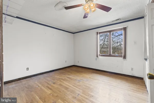 a view of a livingroom with a ceiling fan and window