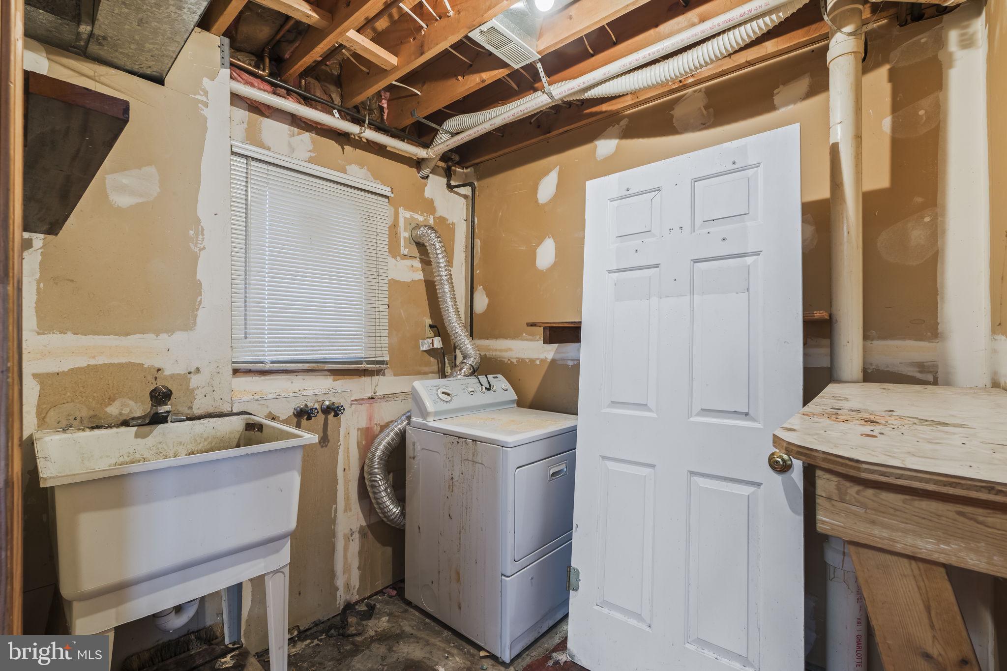 7811 Heflin Drive Clinton, MD 20735 - Photo 45 of 55 a utility room with a sink dryer and washer