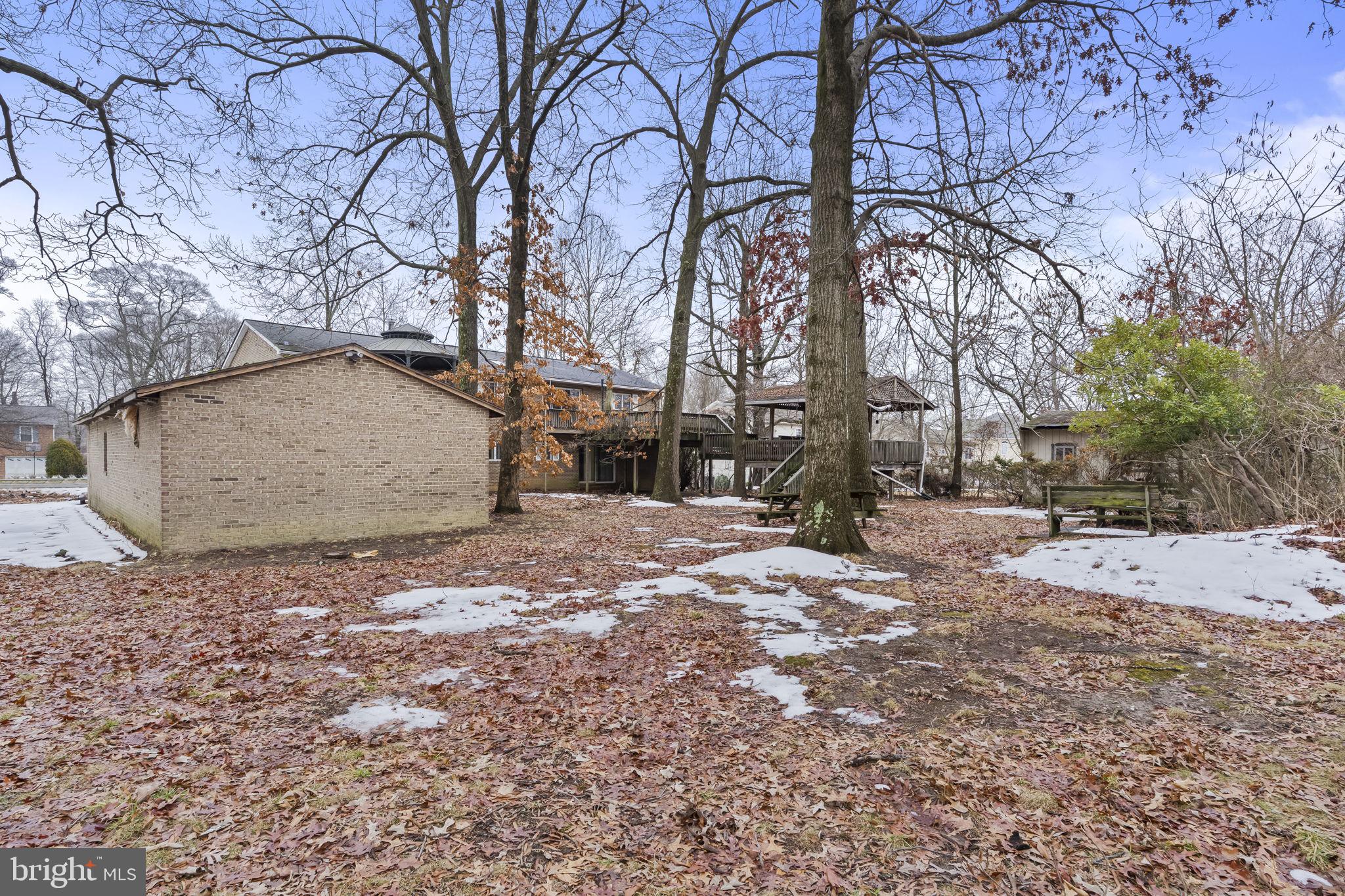7811 Heflin Drive Clinton, MD 20735 - Photo 54 of 55 a backyard of a house with large trees and covered with snow