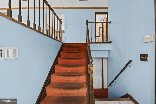 a view of a hallway with wooden floor and entryway