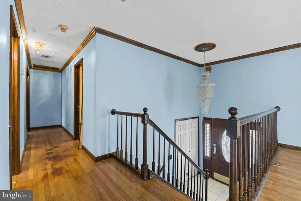 a view of empty room with wooden floor and fireplace