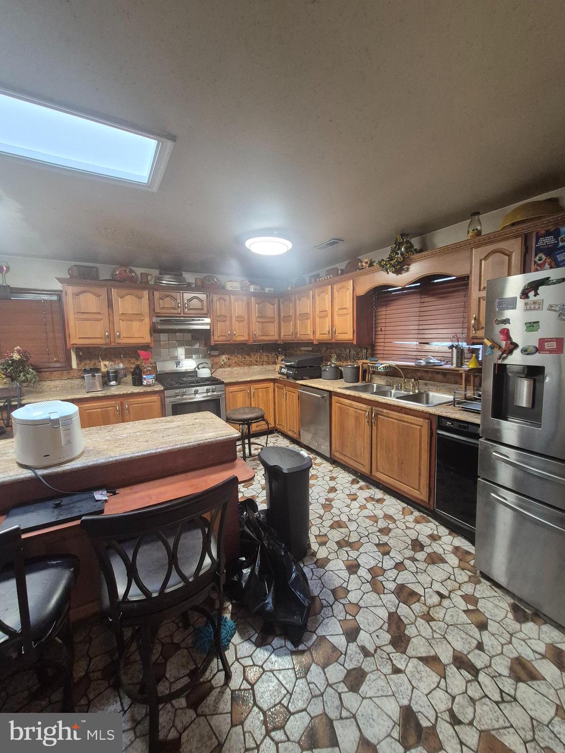 7811 Heflin Drive Clinton, MD 20735 - Photo 8 of 16 a kitchen with stainless steel appliances a stove a sink and a refrigerator