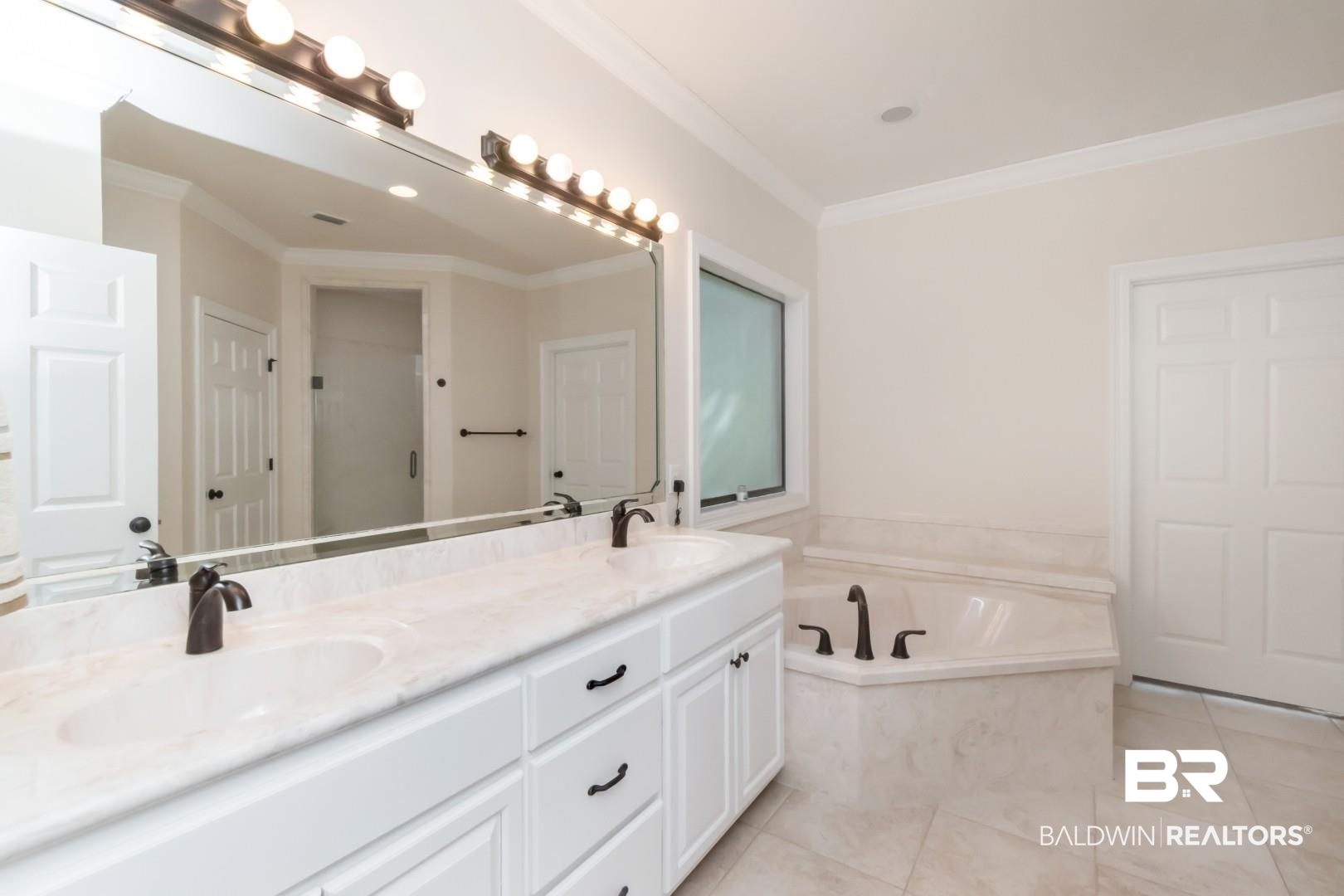 1360 Dykes Road North Mobile, AL 36608 - Photo 17 of 40 Bathroom featuring double vanity, a bath, ornamental molding, light tile patterned floors, and a shower stall