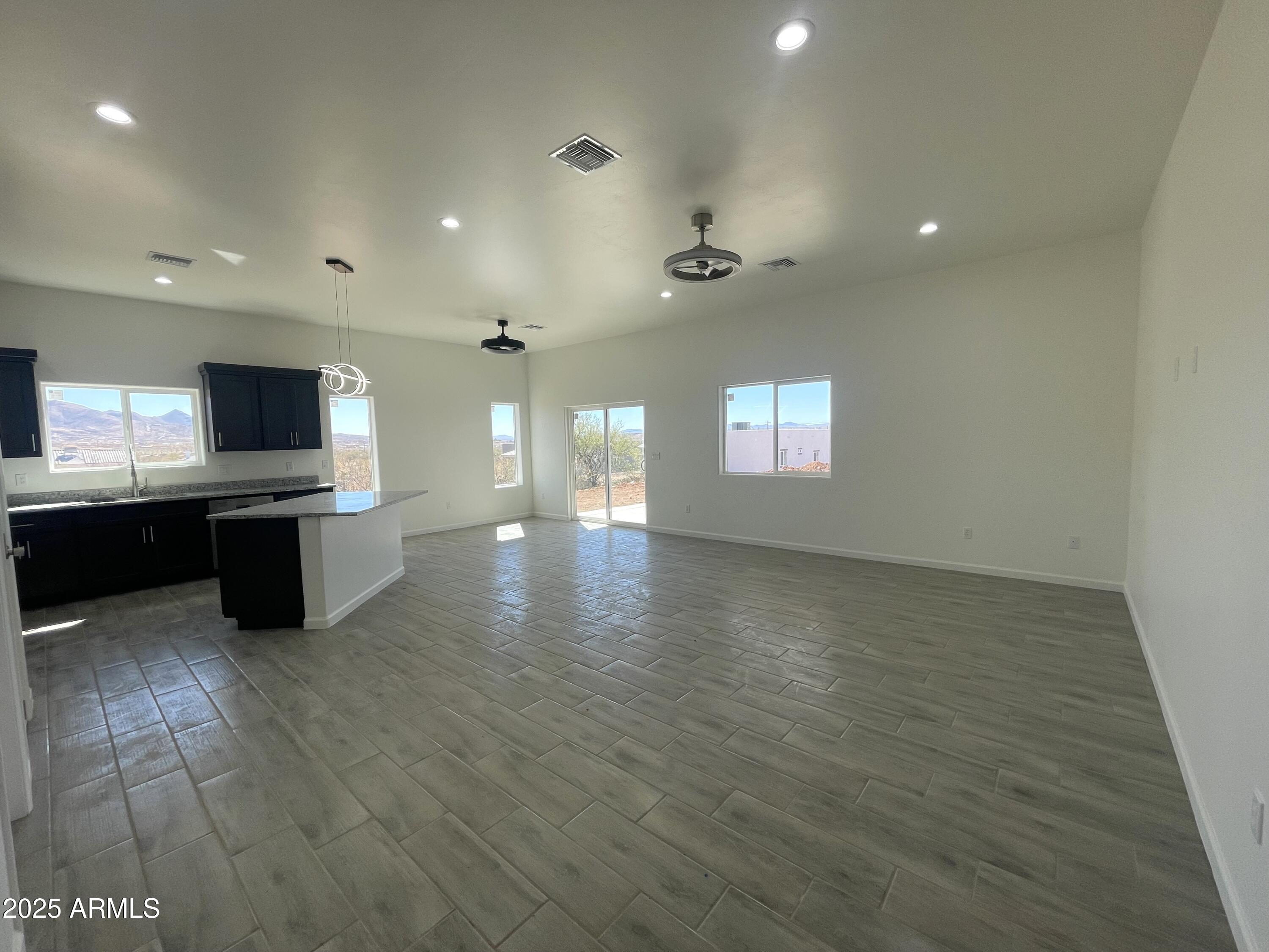 1798 Birmania Corte Rio Rico, AZ 85648 - Photo 13 of 27 a view of kitchen and empty room with wooden floor