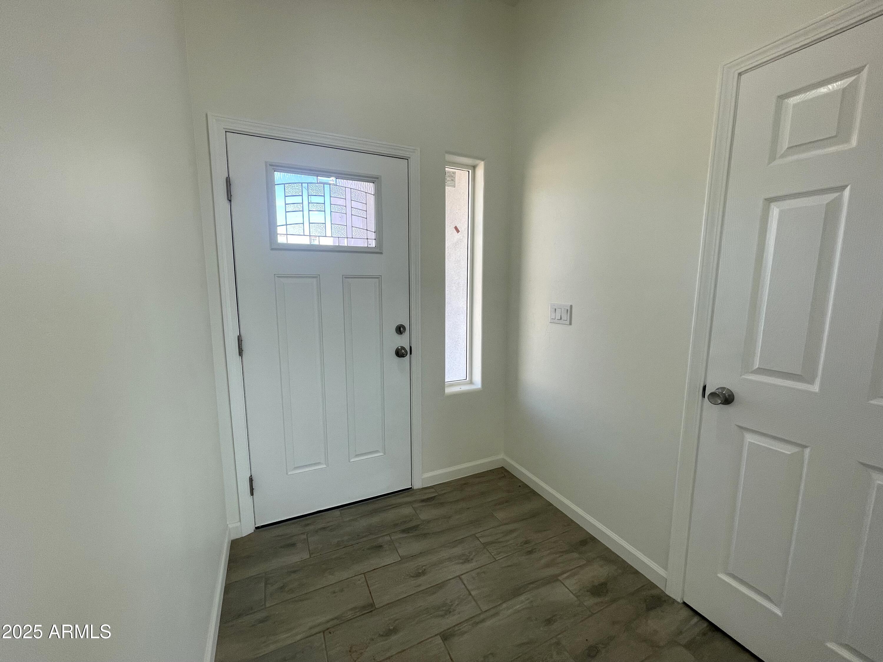 1798 Birmania Corte Rio Rico, AZ 85648 - Photo 15 of 27 a view of an empty room with window and hallway