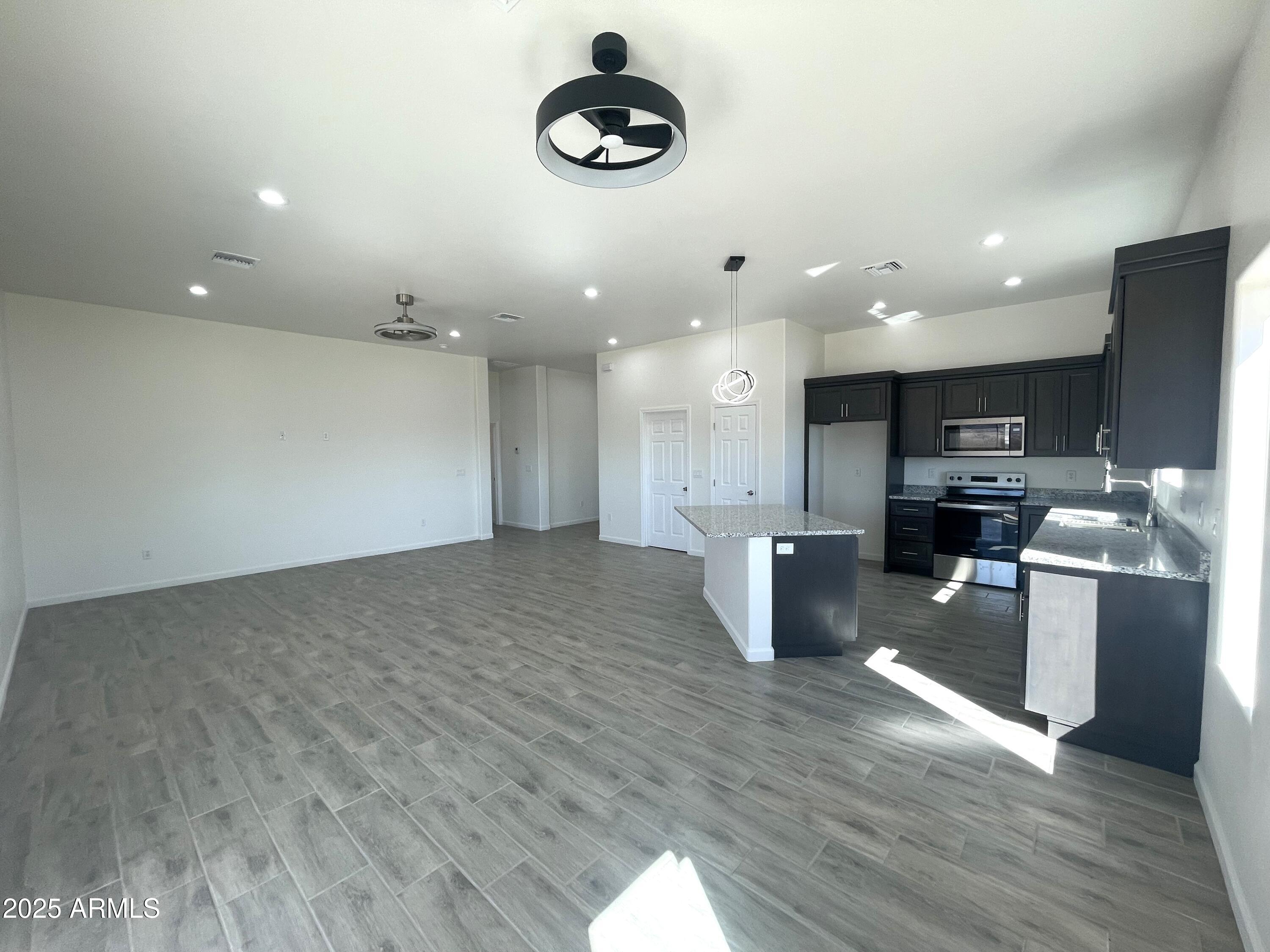 1798 Birmania Corte Rio Rico, AZ 85648 - Photo 9 of 27 a kitchen with a refrigerator and a stove top oven