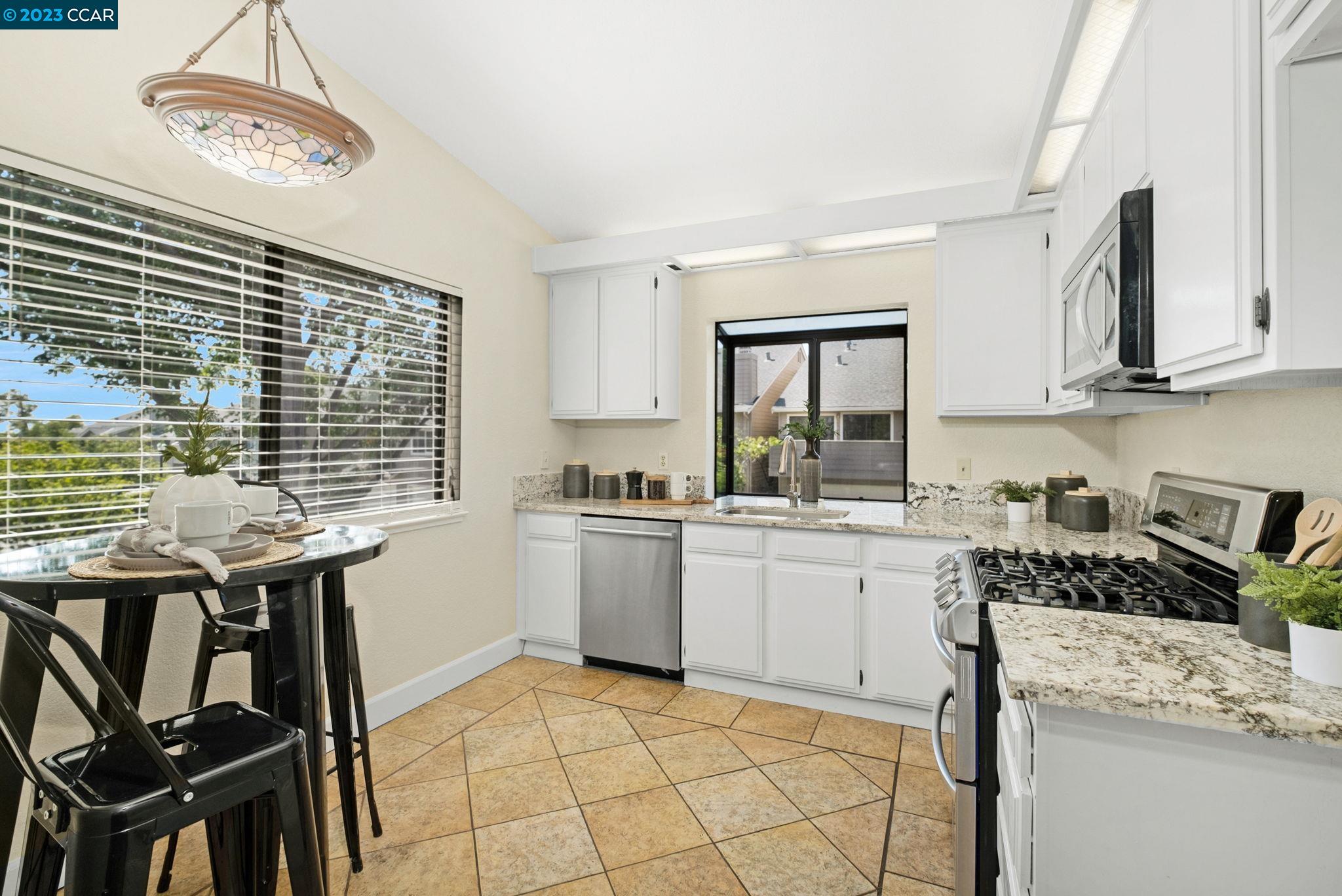 570 Bustos Place Bay Point, CA 94565 - Photo 12 of 26 a kitchen with a stove a sink and cabinets
