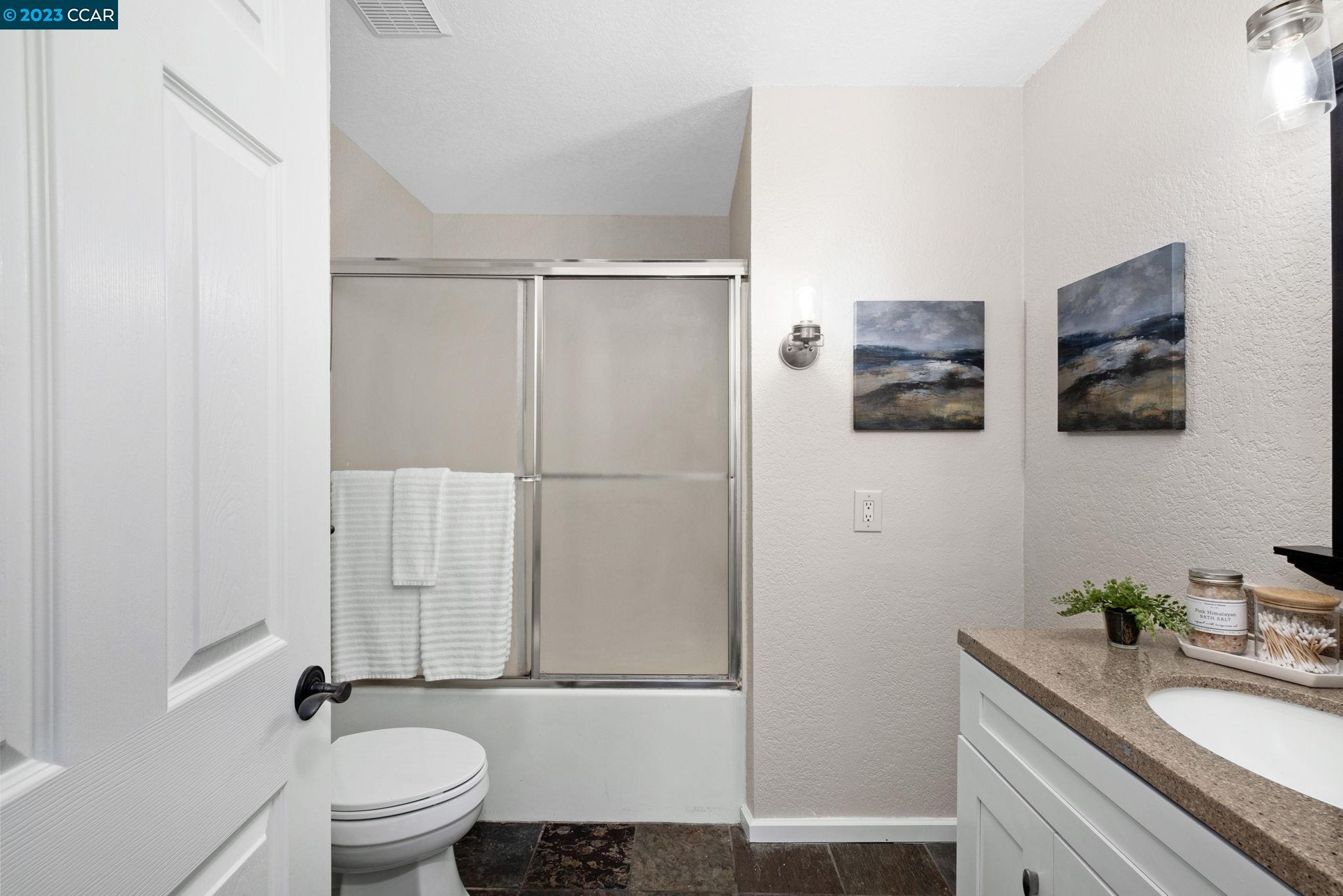 570 Bustos Place Bay Point, CA 94565 - Photo 17 of 26 a bathroom with a granite countertop sink toilet and shower