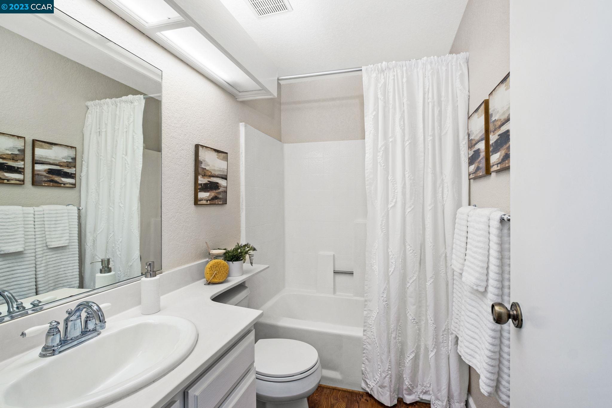 570 Bustos Place Bay Point, CA 94565 - Photo 19 of 26 a bathroom with a sink toilet and shower
