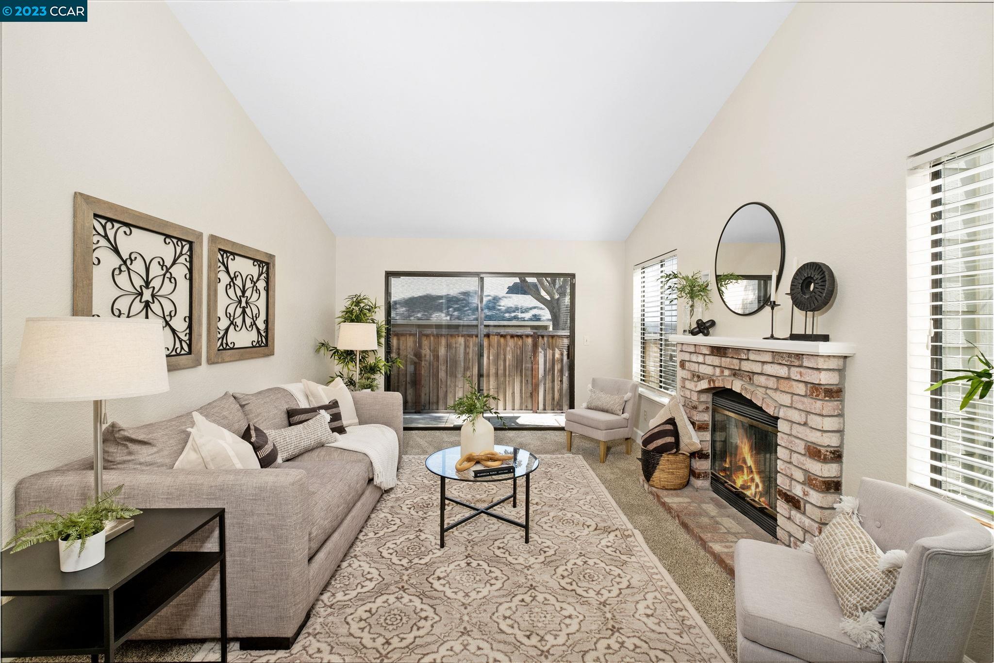 570 Bustos Place Bay Point, CA 94565 - Photo 8 of 26 a living room with furniture a fireplace and a floor to ceiling window