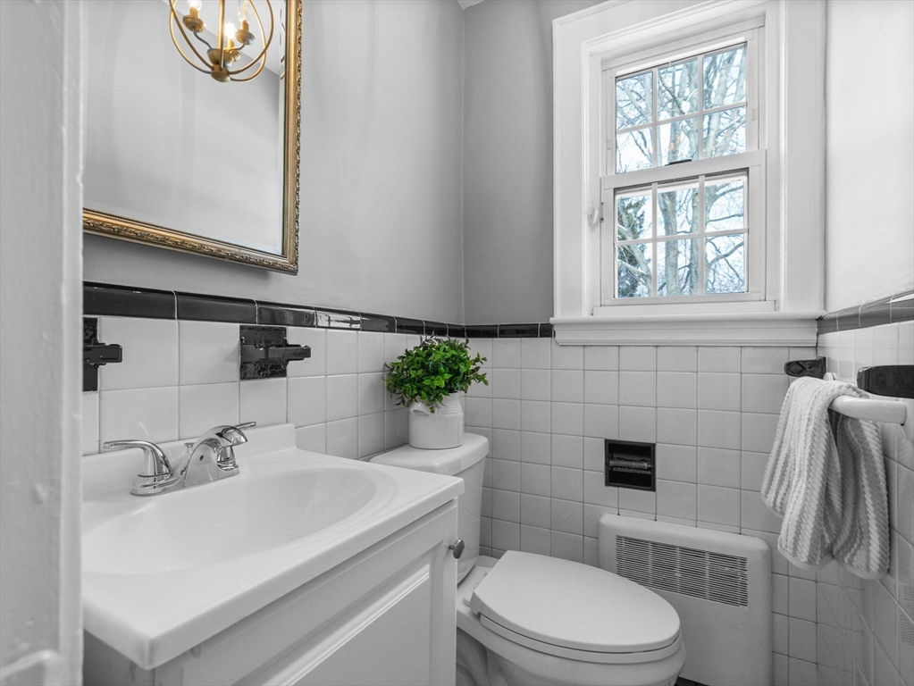7 Neillian Crescent Boston, MA 02130 - Photo 15 of 29 a bathroom with a sink a toilet and a window