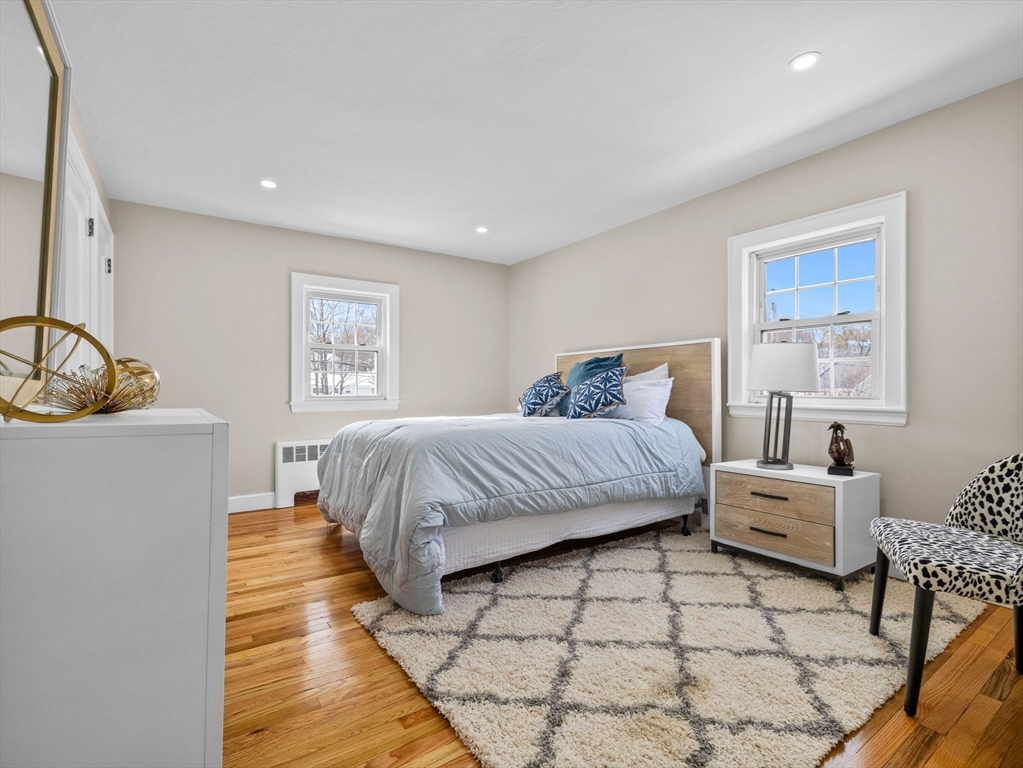 7 Neillian Crescent Boston, MA 02130 - Photo 16 of 29 a bedroom with a bed and a couch