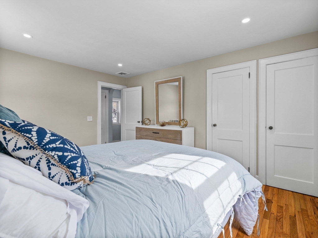 7 Neillian Crescent Boston, MA 02130 - Photo 17 of 29 a bedroom with a large bed and a dresser