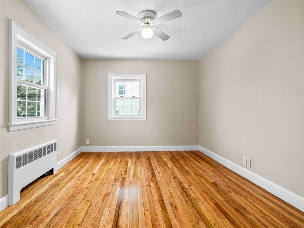 7 Neillian Crescent Boston, MA 02130 - Photo 19 of 29 a view of an empty room with wooden floor and a window