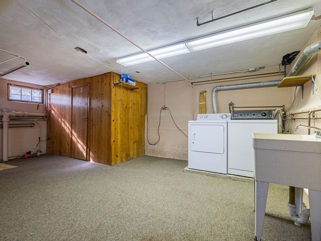 7 Neillian Crescent Boston, MA 02130 - Photo 22 of 29 a view of a storage & utility room with washer and dryer