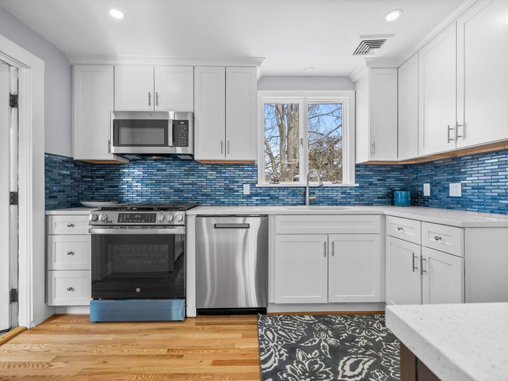7 Neillian Crescent Boston, MA 02130 - Photo 6 of 29 a kitchen with stainless steel appliances granite countertop a stove a sink and a microwave