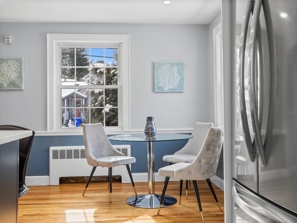 7 Neillian Crescent Boston, MA 02130 - Photo 9 of 29 a view of a dining room with furniture a rug and wooden floor