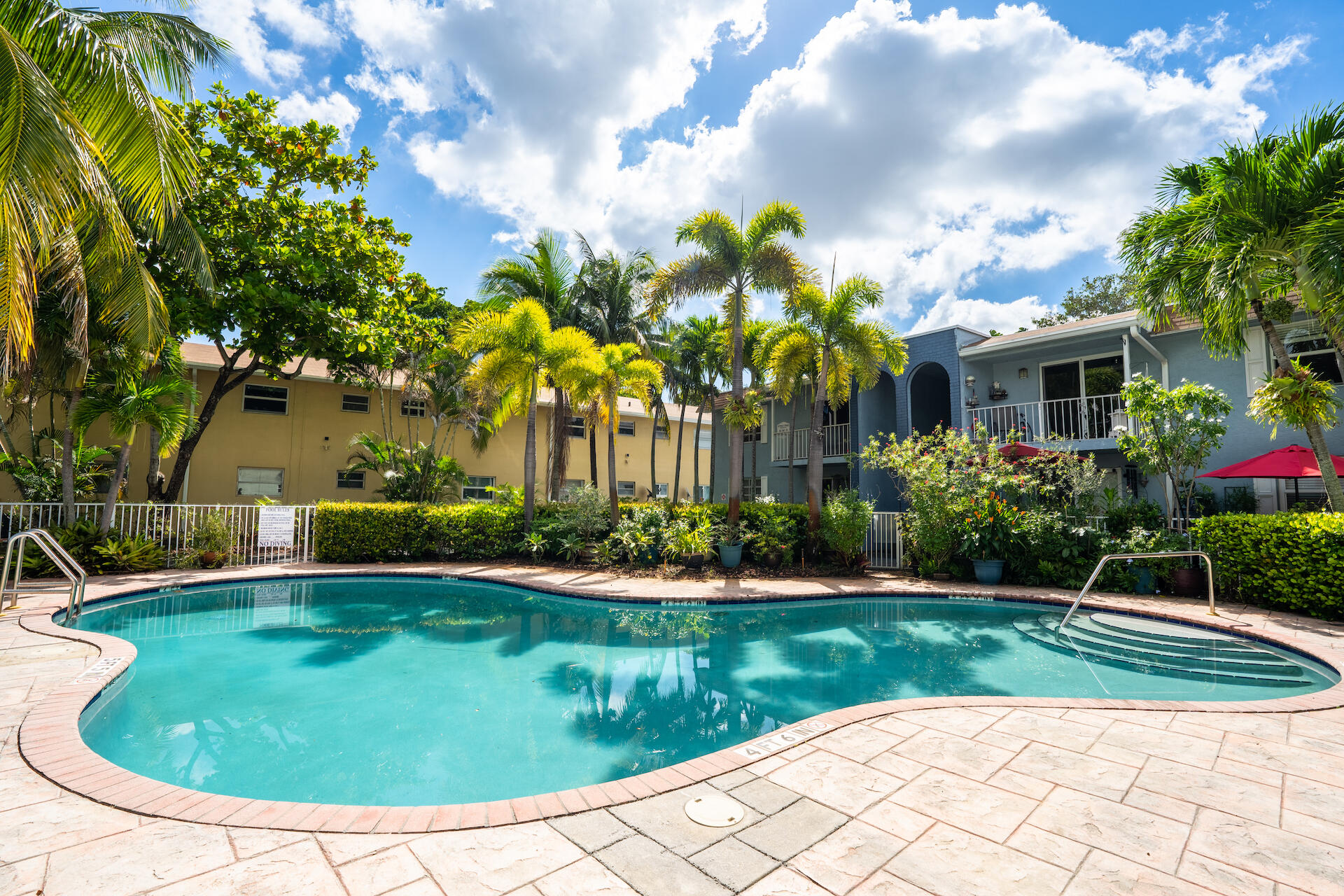 2607 Northeast 8th Avenue, Unit 1 Wilton Manors, FL 33334 - Photo 1 of 22 a view of a swimming pool with a garden
