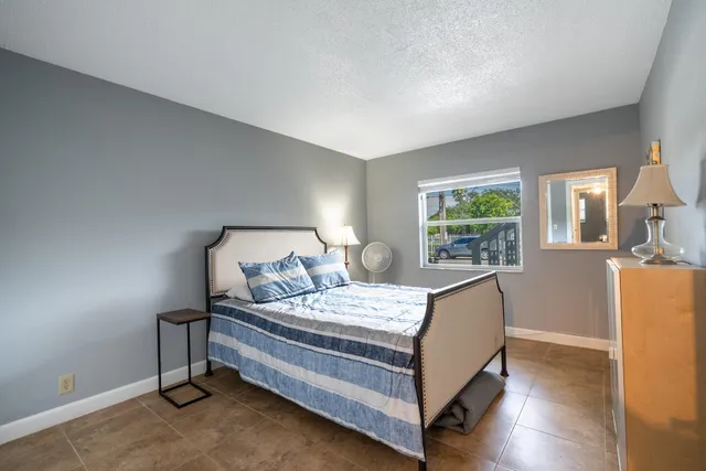 a bedroom with a bed and a table in it