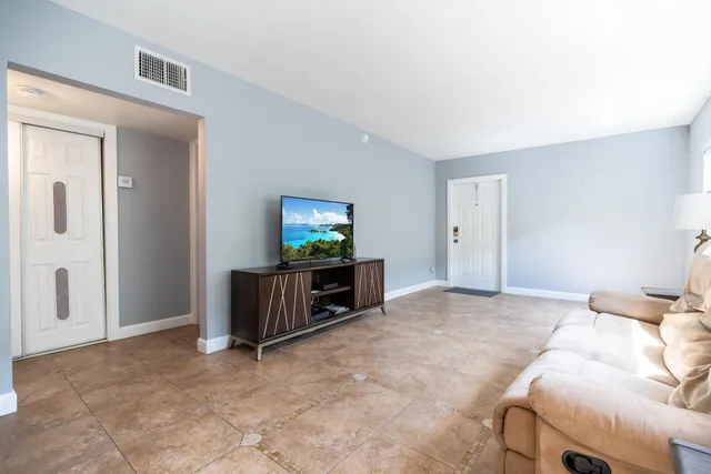 a bed room with a bed and a television