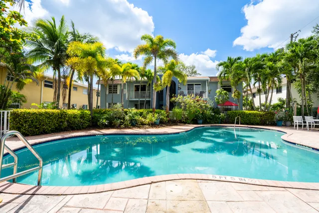 a front view of house and yard with swimming pool and trees