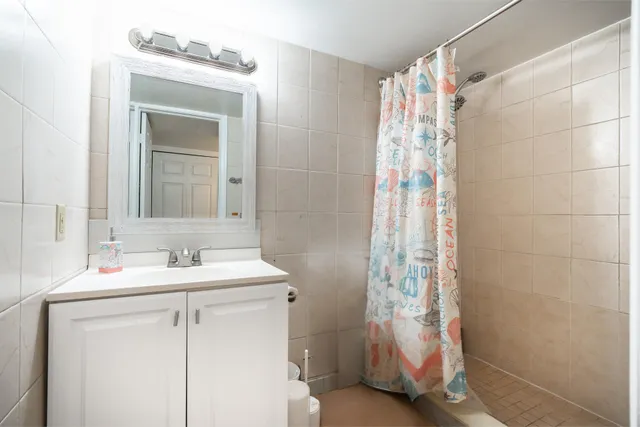 a bathroom with a sink a mirror and a shower
