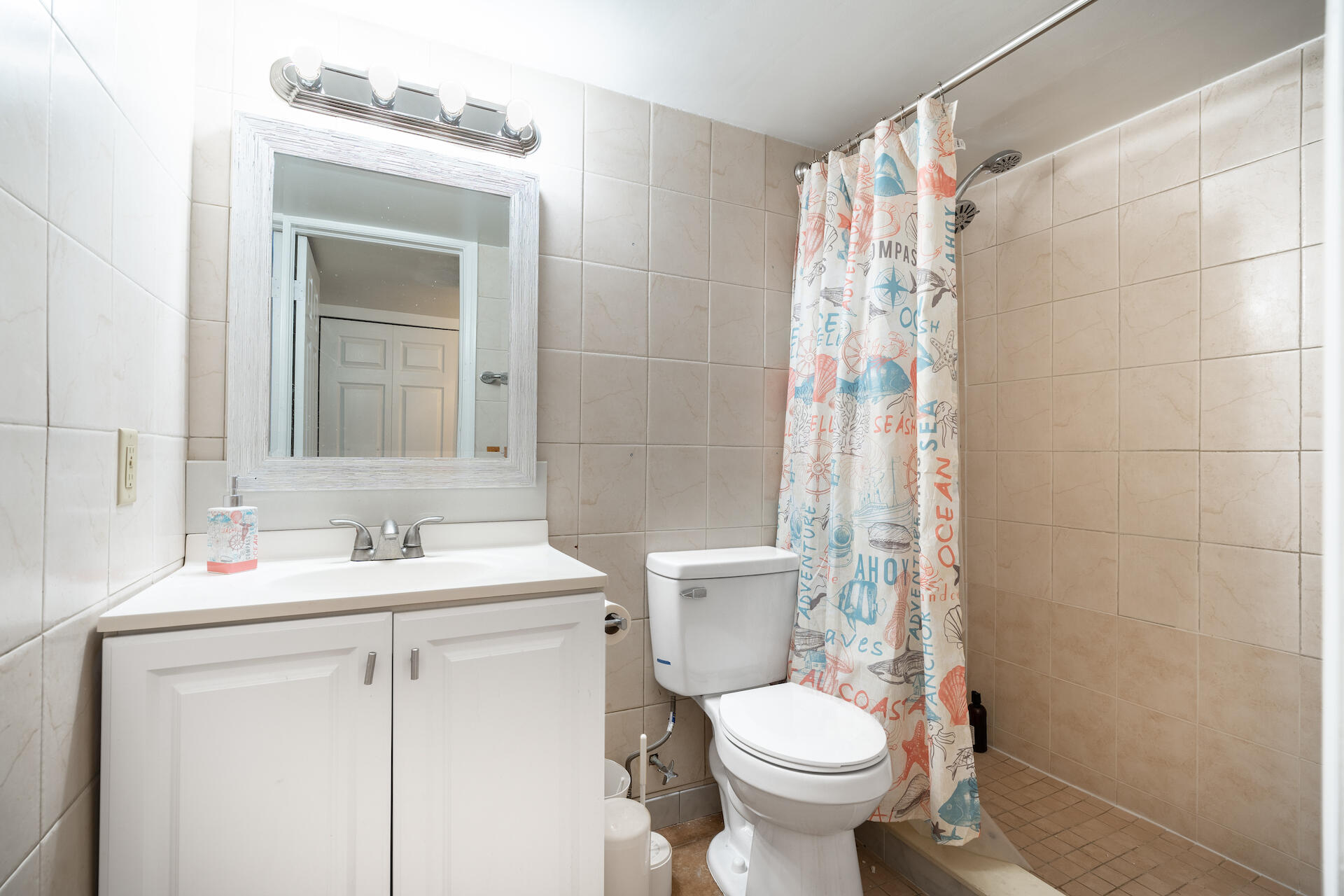 2607 Northeast 8th Avenue, Unit 1 Wilton Manors, FL 33334 - Photo 21 of 22 a bathroom with a sink toilet and shower