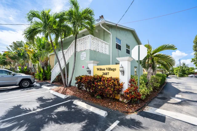 a view of a street with potted plants