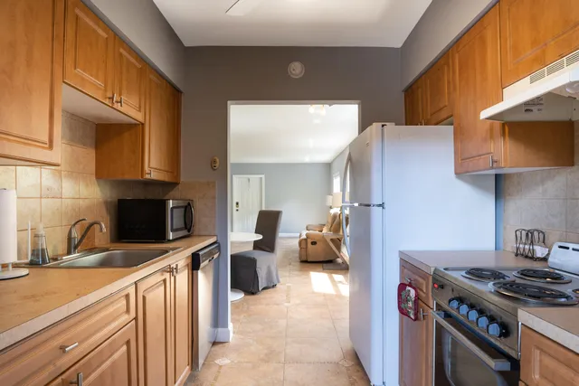 a kitchen with stainless steel appliances a stove a sink and a microwave