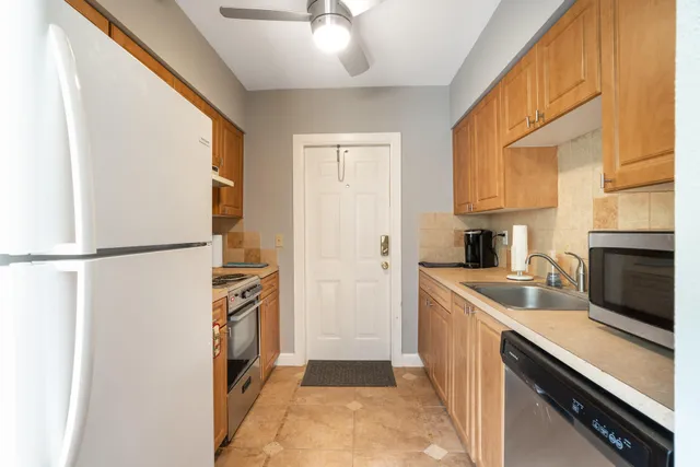 a kitchen with a sink and a refrigerator