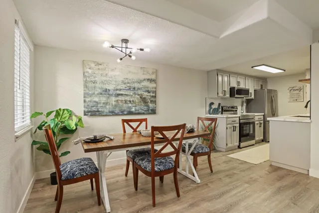 a kitchen with stainless steel appliances a sink stove and refrigerator