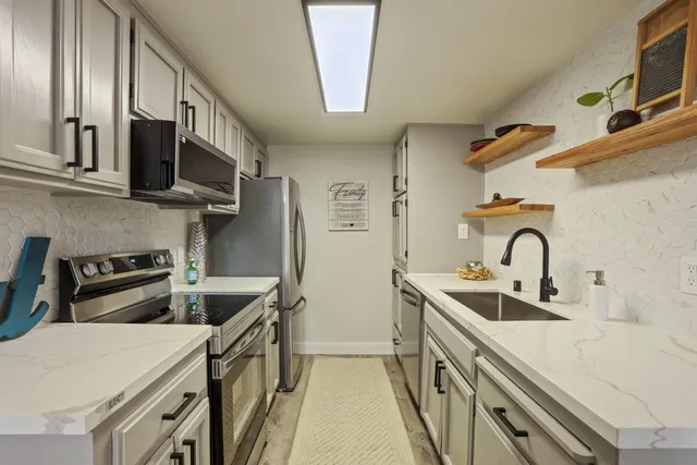 a bathroom with a sink mirror and toilet