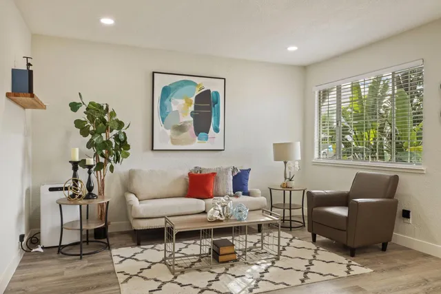 a view of a dining room with furniture and a chandelier