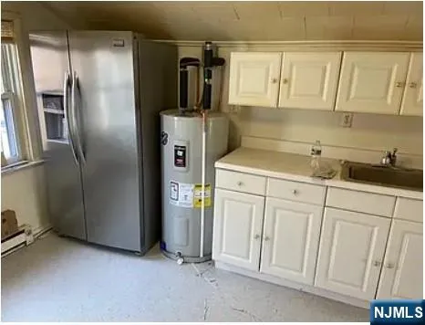 a kitchen with a refrigerator and cabinets