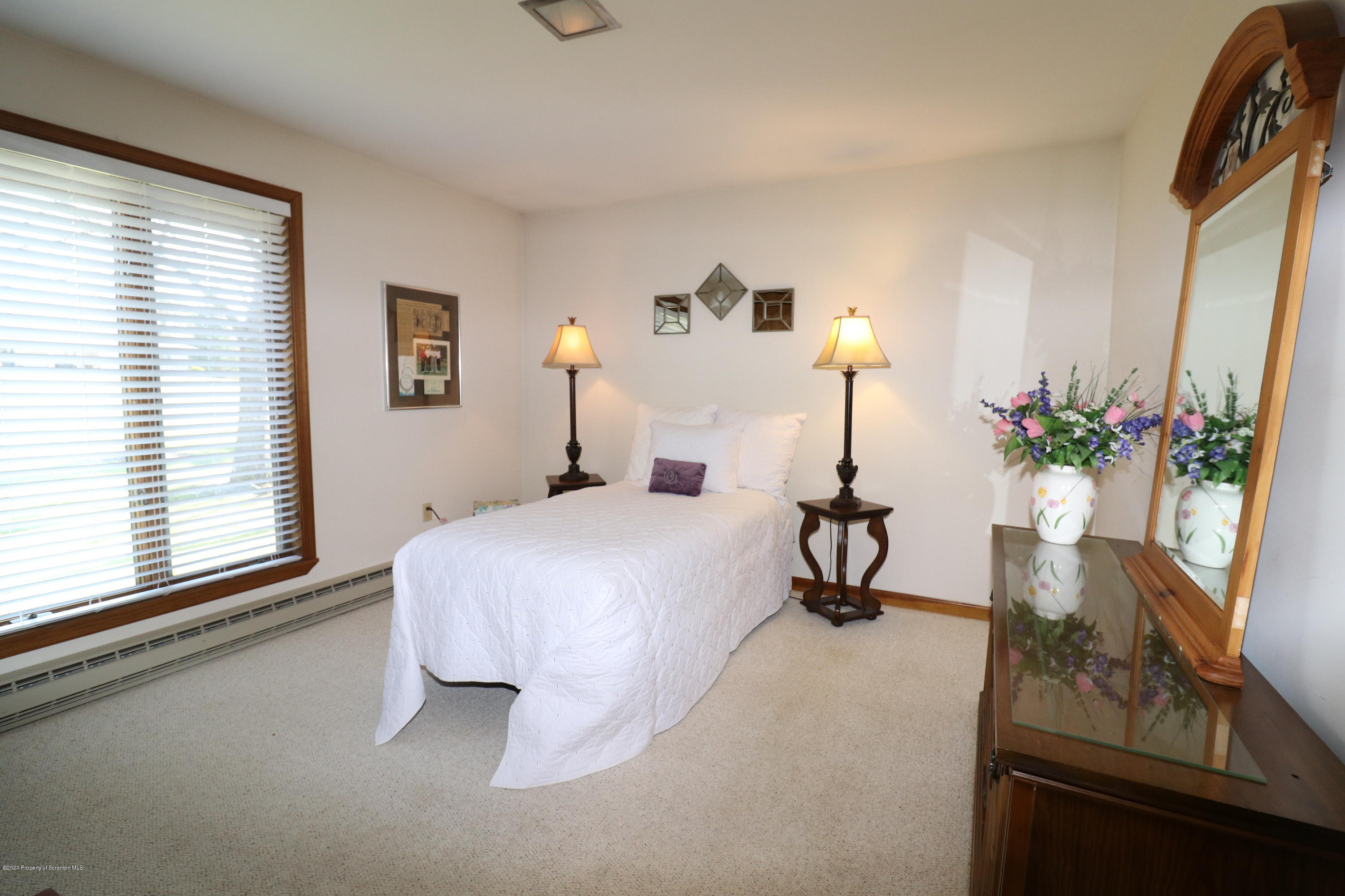 840 Forest Road Lake Ariel, PA 18436 - Photo 9 of 50 a bedroom with a bed and a potted plant