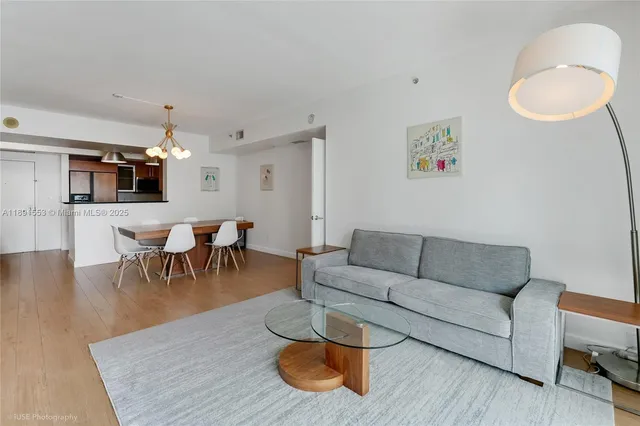 a living room with furniture and a dining table