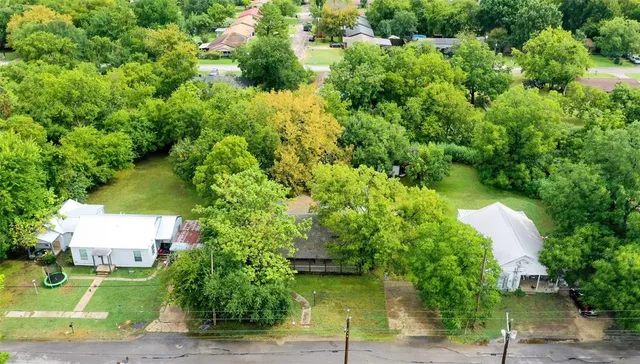 an aerial view of house with yard swimming pool and outdoor seating