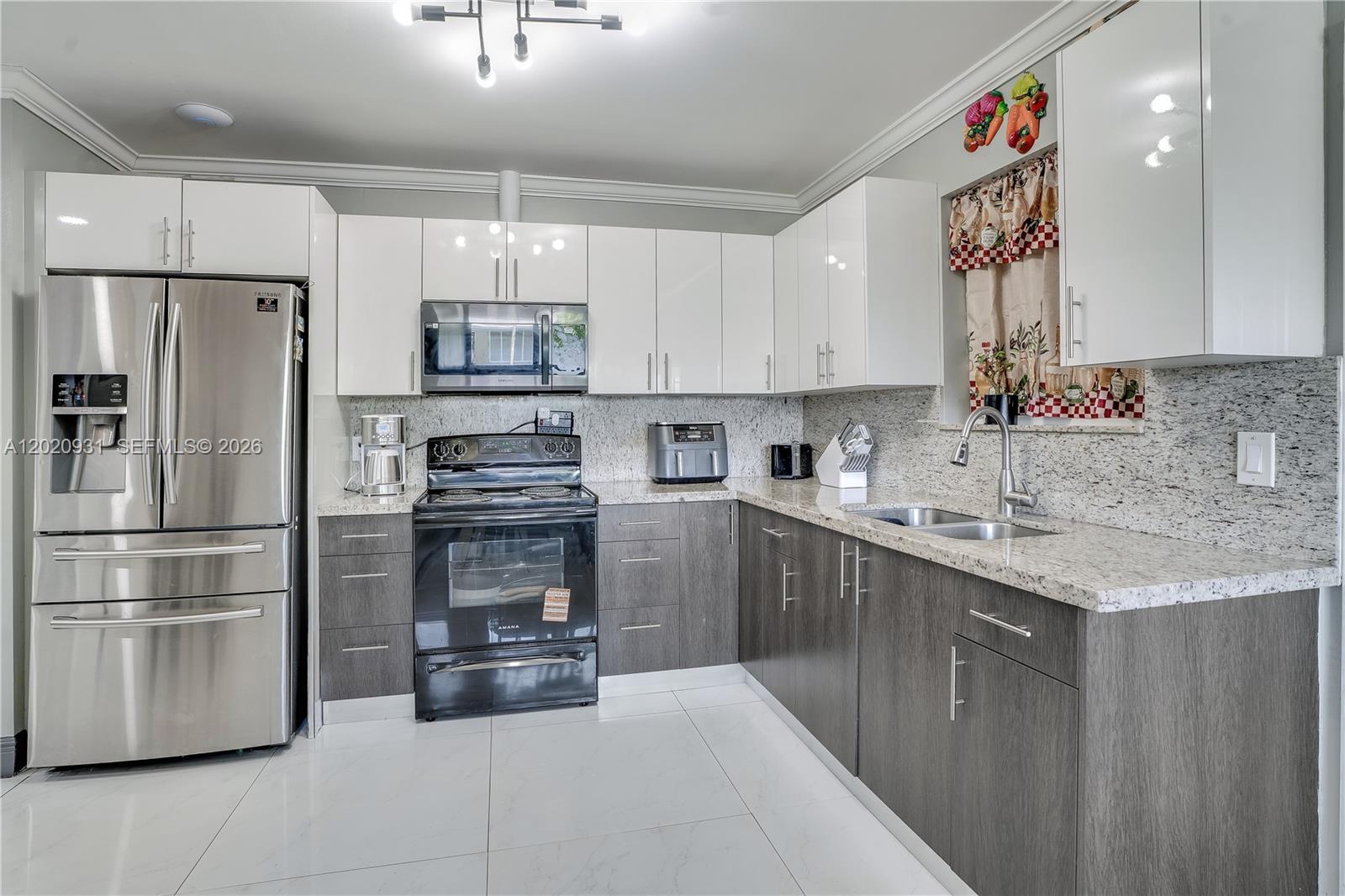 1360 Northwest 77th Street Miami, FL 33147 - Photo 9 of 41 a kitchen with granite countertop a refrigerator and a stove top oven