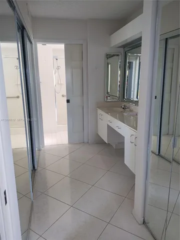 a bathroom with a sink a mirror and a bathtub