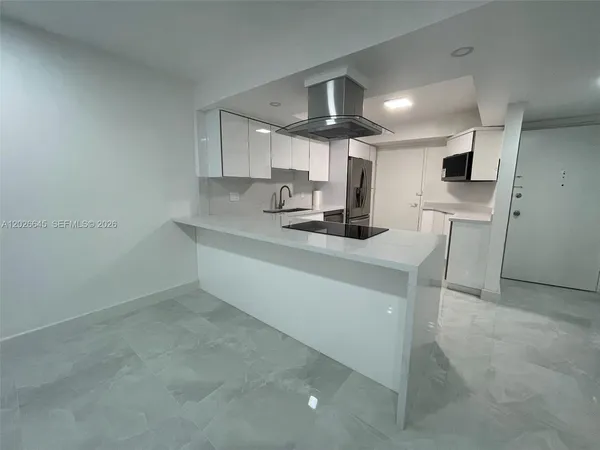 a kitchen with a sink cabinets and stainless steel appliances