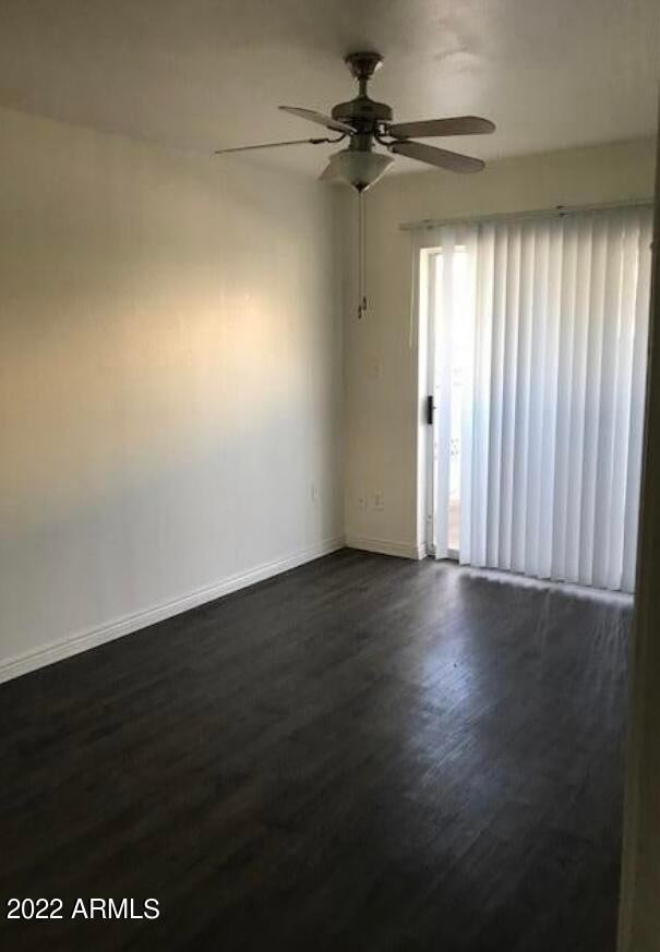 2021 West Hayward Avenue, Unit 11 Phoenix, AZ 85021 - Photo 11 of 14 an empty room with wooden floor and windows