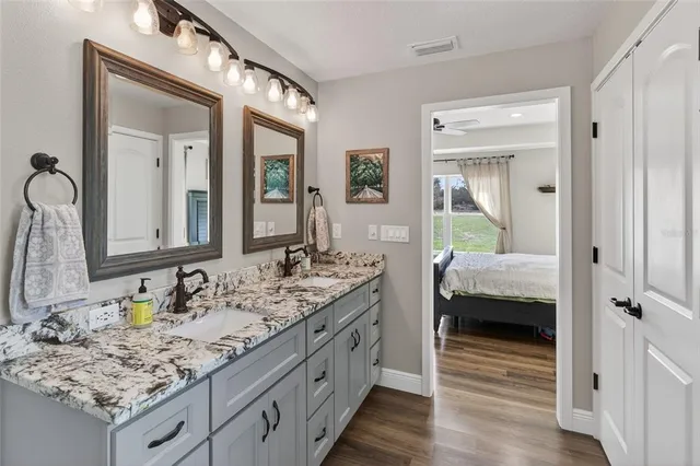 a bedroom with a bed and a painting on the wall