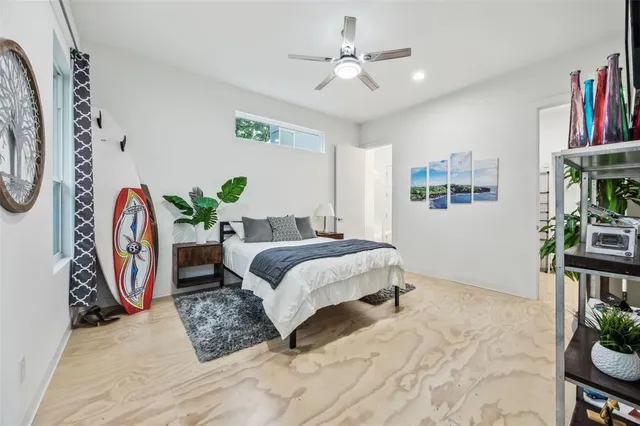 a spacious bedroom that has a bed and a chair in it