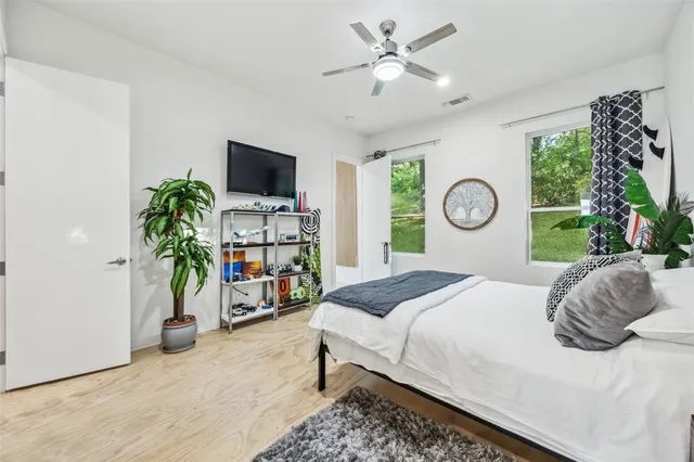 a bedroom with a bed and a window