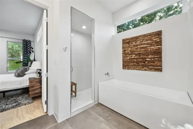 a bathroom with a bathtub and a shower