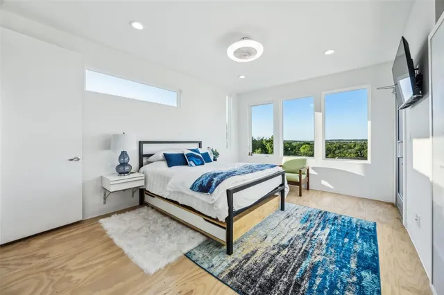 a bedroom with bed and wooden floor